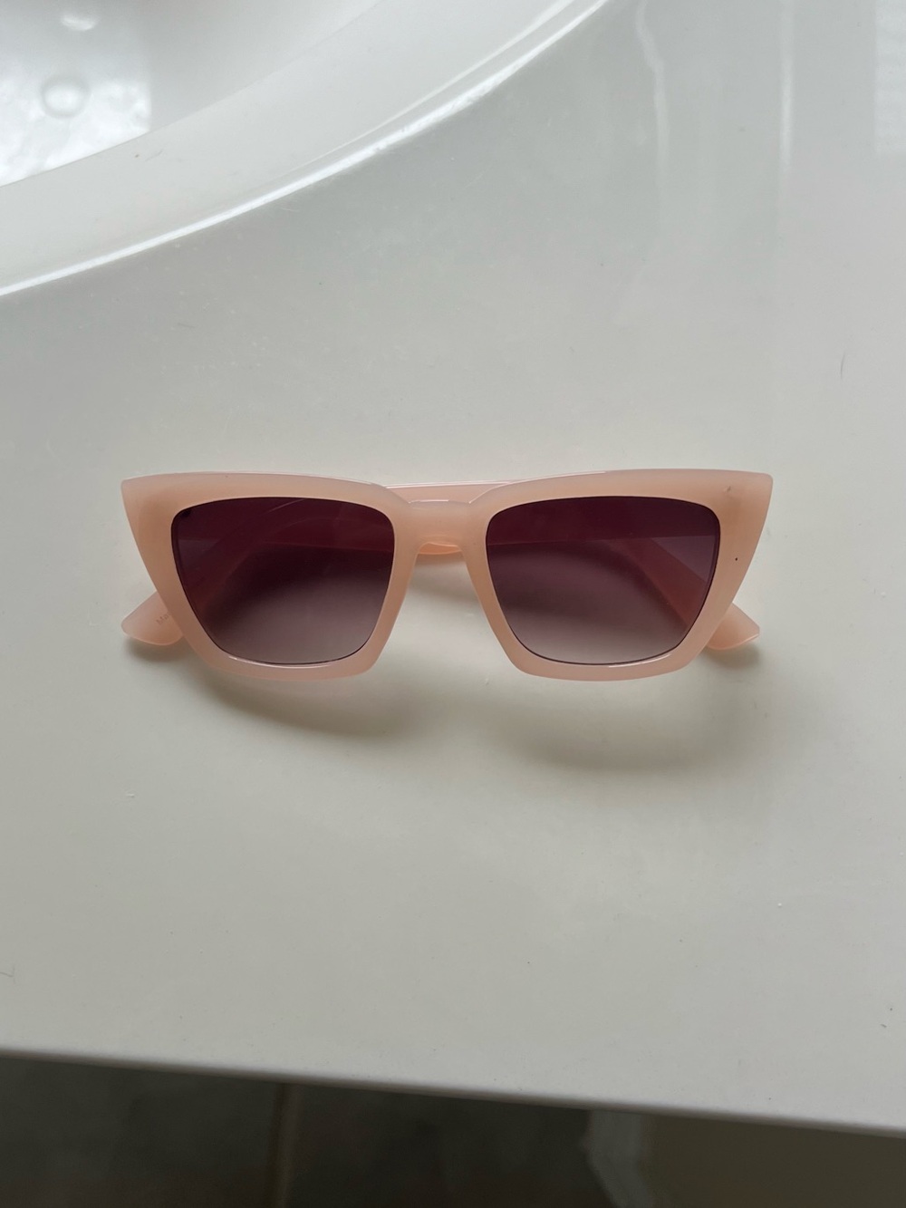 Pink cat eye sunglasses with gradient lenses